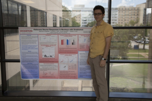 Agaoglu with his award-winning poster from the ARVO conference.