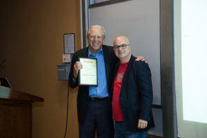 NAE Member and Rockwell lecturer Michael Kavanaugh, left, accepts plaque from Roberto Ballarini, chair of civil engineering