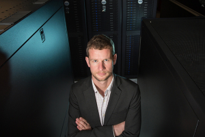 Jeremy Palmer with the big guns: The high-performance computers that store his data