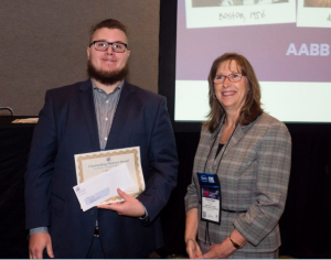 Cullen College doctoral student Nathaniel Piety with award given by Donna M. Regan, president of AABB 