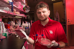 Sergey Shevkoplyas, associate professor of biomedical engineering, with the two components of this project – blood and the CIF system that isolates leukocytes