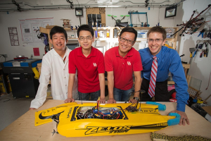 The brains in the lab: From left to right, Zhu Han, Jiefu Chen, Miao Pan, Aaron Becker and robot