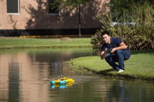 Becker's student Haoran Zhao launches drone at pond by the Cullen College
