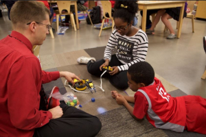 Dr. Becker isn't just playing with robots, he's teaching his students and elementary students