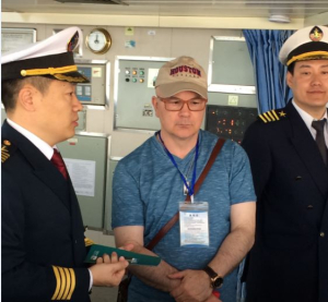 Roberto Ballarini (center) tours the training ship Yukun with a member of the staff and Captain Xinzhuo Liu (far left)