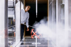 Daniel Araya, assistant professor of mechanical engineering, demonstrates how his wind tunnel can generate electricity. Photo courtesy of Michael Ciaglo, Houston Chronicle Staff