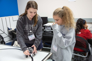 Julie Rogers, a Cullen College mechanical engineering senior and a G.R.A.D.E. Camp counselor, works with camper Natalie Cramer, an 8th-grader from Pearland. 