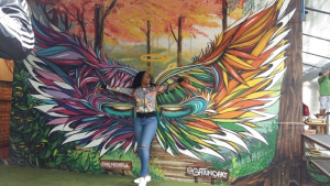 Rosa Futy, a UH chemical engineering student, poses with some Brazilian street art.