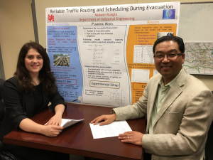 Professor Gino Lim and his doctoral student Ayda Darvishan with a poster about their emergency evacuation project.