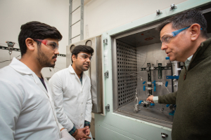 Konstantinos Kostarelos, an associate professor of petroleum engineering, with two graduate students (Pushpesh Sharma in the center, Parth Jain to the left) in his Subsurface Research Lab. 