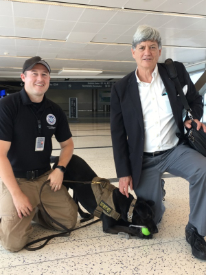 Stuart Long, UH professor of electrical and computer engineering, with a TSA handler and his passenger-screening canine. 