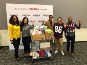 PROMES representatives with 140 pounds of donations for the UH PEEPS Pantry, a free food pantry to help students in need. 
