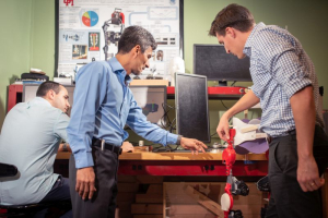 Manuel Cestari, Jose Contreras-Vidal and David Eguren work on the construction of a pediatric exoskeleton for brain-computer interfaced mobility. 