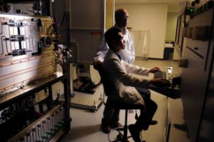 Venkat Selvamanickam, standing, director of the Applied Research Hub, talks with SuperPower employee Albert Guevara at a machine that produces superconducting wire at the University of Houston's Energy Research Park. Photo: Dave Rossman / © 2012 Dave Rossman. (Photo provided by Houston Chronicle.) UH Energy Research Park Featured in Houston Chronicle