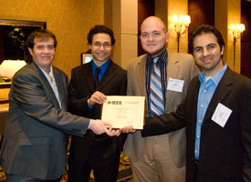 Team members James Beamer (left), Carlos Moran, John Hemmick and Osaid Shamsi show off the award signifying their first place win in the robotics competition at the Institute of Electrical and Electronics Engineers (IEEE) Region 5 Technical, Professional and Student Conference April 17. Contributed Photo. 