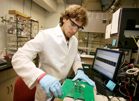 Chemical engineering senior Rhys Forgie works in the lab as part the college's Research Experience for Undergraduates program. Photo by Thomas Shea. 