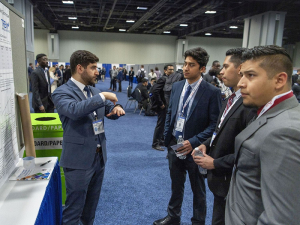 Santiago El Awad (left) speaking at the annual conference for the Dwight David Eisenhower Transportation Fellowship Program. El Awad has earned the fellowship three years in a row.
