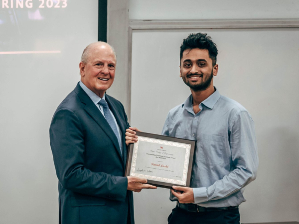 Dean Joseph W. Tedesco presents Varad Joshi, teaching assistant in Chemical and Biomolecular Engineering, with a Teaching Excellence Award.