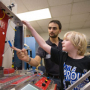 Logan Craft, 10, is given a demonstration on smart materials by Ph.D. student Claudio Olmi during one stop on a tour of the college June 30. Photo by Thomas Shea.