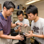 Professor Richard Liu (left) works with graduate students Yu Cai and Yinan Xing on the vehicle-mounted laser device developed in the Cullen College's Subsurface Sensing Lab. Photo by Thomas Shea