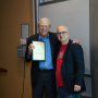 NAE Member and Rockwell lecturer Michael Kavanaugh, left, accepts plaque from Roberto Ballarini, chair of civil engineering