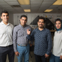 Iceman: Assistant Professor Hadi Ghasemi (far left) is joined by students Seyed Mohammad Sajadi, Peyman Irajizad and Nazanin Farokhnia. Irajizad holds the new magnetic slippery surface.