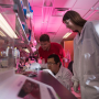 In the blood lab, where everything seems cast in red, are from left, Sergey Shevkoplyas, associate professor of biomedical engineering, and post doc fellows Hui Xia and Briony Strachan