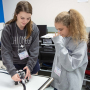 Julie Rogers, a Cullen College mechanical engineering senior and a G.R.A.D.E. Camp counselor, works with camper Natalie Cramer, an 8th-grader from Pearland. 