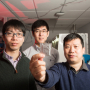 Dr. Yan Yao holds the solid-state battery, with Dr. Yanliang Liang next to him and Dr. Xiaowei Chi behind them at the UH Cullen College of Engineering.