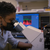 Ikelle, conducting research in a BME lab. 