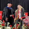 Dean Joseph W. Tedesco presents Ann Clark with her degree during a graduation ceremony in May 2023. 