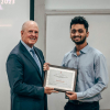 Dean Joseph W. Tedesco presents Varad Joshi, teaching assistant in Chemical and Biomolecular Engineering, with a Teaching Excellence Award.