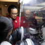 As Assistant Professor Xiaonan Shan observes, recent UH graduate Guangxia Feng works on the operando reflection interference microscope (RIM) inside a “glove box,” since the lithium-ion battery electrolyte is flammable.