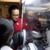 As Assistant Professor Xiaonan Shan observes, recent UH graduate Guangxia Feng works on the operando reflection interference microscope (RIM) inside a “glove box,” since the lithium-ion battery electrolyte is flammable.