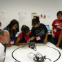 Professor Glover guides campers in building and programming their robot.