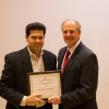 Grigoriadis Accepts Award From Dean Tedesco