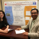 Professor Gino Lim and his doctoral student Ayda Darvishan with a poster about their emergency evacuation project.