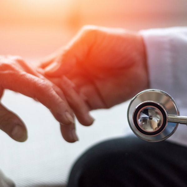 Dr. touching patient's hand